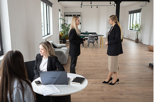 Two businesswomen collaborate over, a Technology Photo by undrey