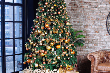 Interior with couch and decorated ch featuring ball, bauble, and bead