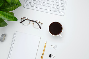 White workspace with cactus, green plant, eyeglasses, and coffee mug for produc, a Photo by matucha