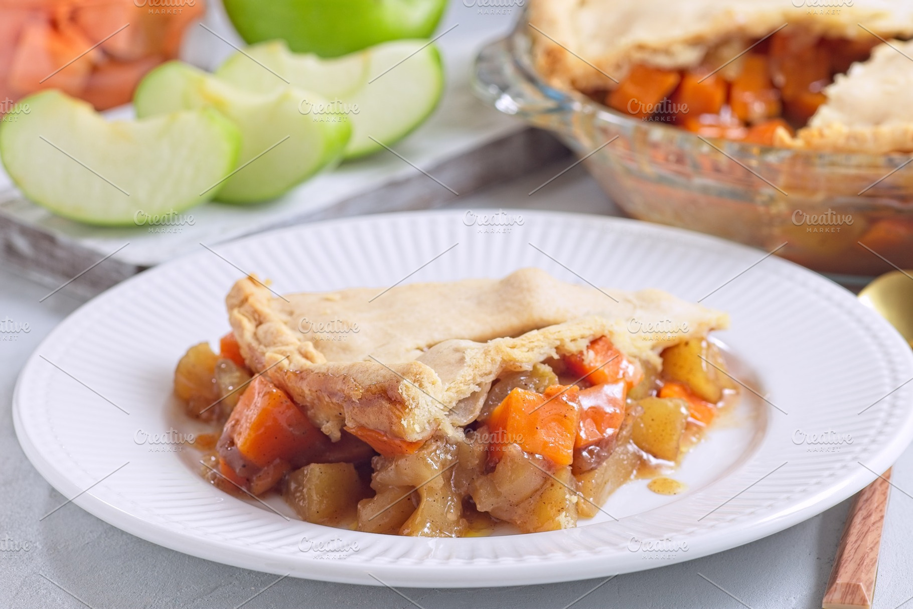 Delicious homemade apple and sweet potato cobbler pie showing filling ingredien, a Food & Drink Photo by iuliia_n