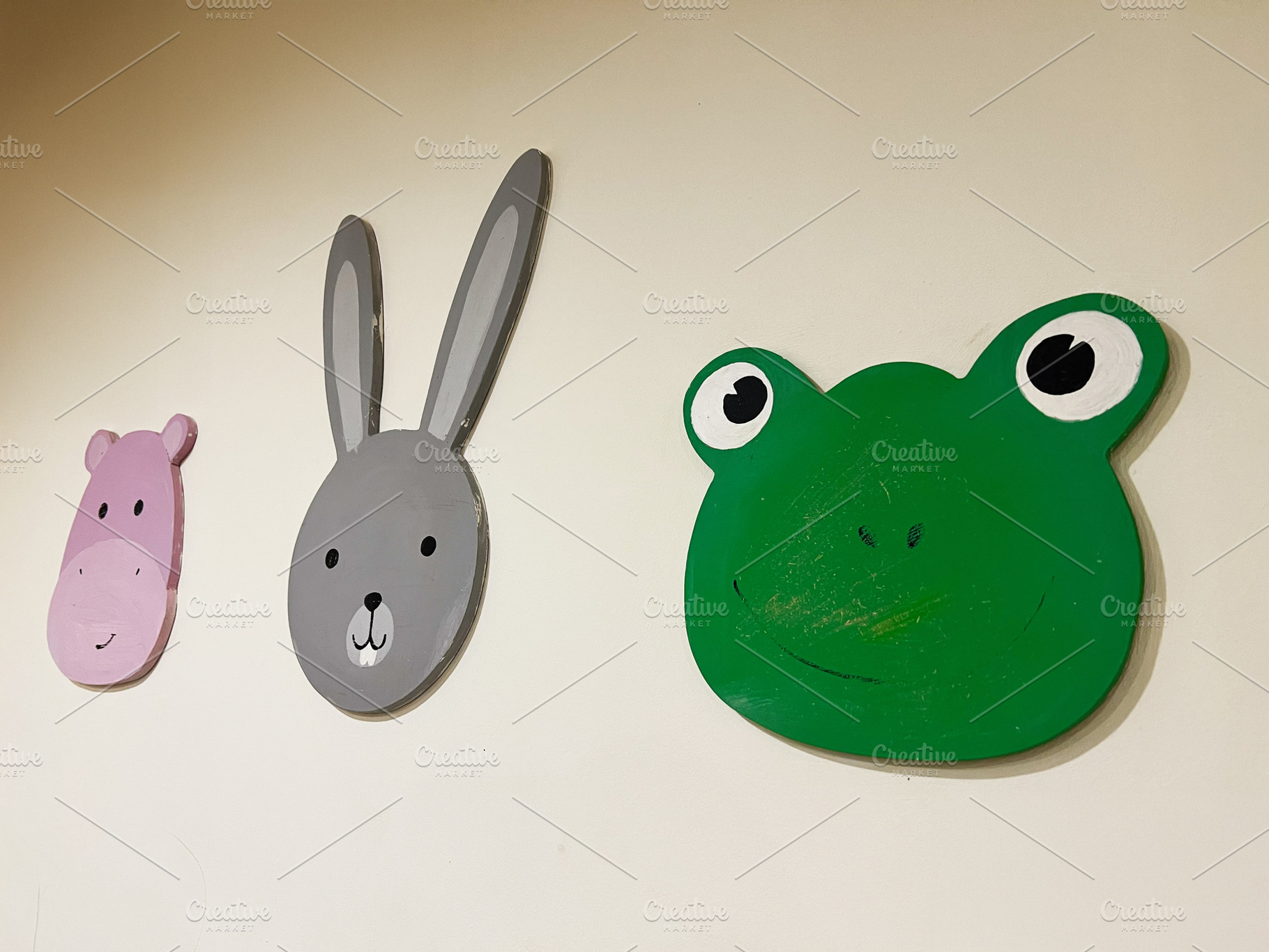 Animal face wall decorations featuring frog, rabbit, and hippo in playful desig, a Photo by AS photostudio