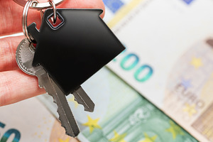 Hand holding house keys over euro currency, a Business Photo by Olena Rudo