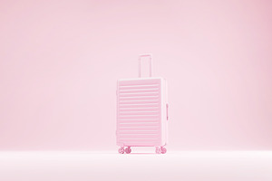 Suitcase on pink pastel background.