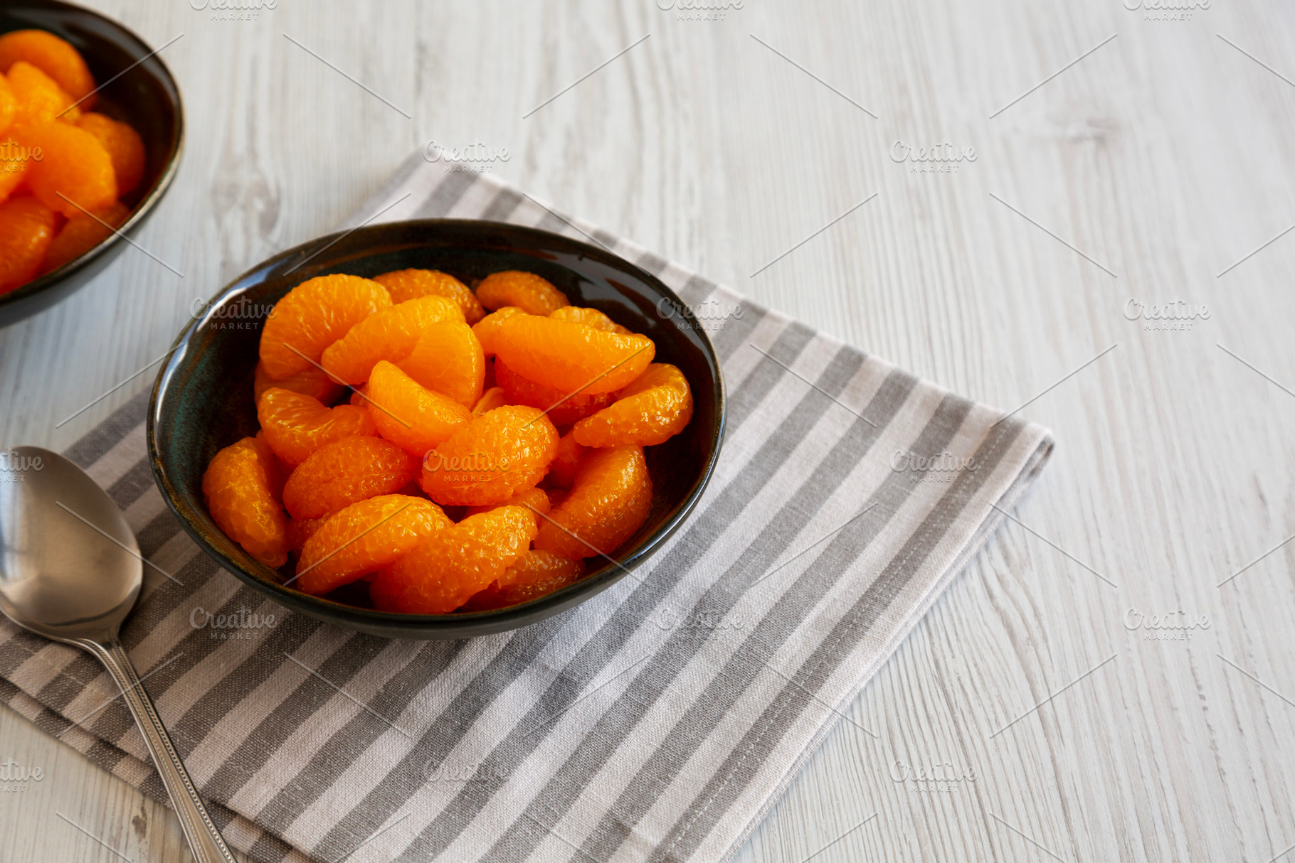 Organic Canned Mandarin Oranges in Bowls, side view. Copy space., a Food & Drink Photo by LiudmylaChuhunova