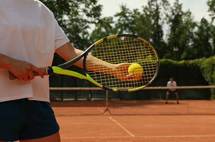 Woman hold racket and tennis ball on clay court, a Sports & Recreation Photo by AtlasStudio PRO