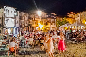 Night crowd dining in historic guimaraes square, portugal, a Person Photo by DanFLCreativo