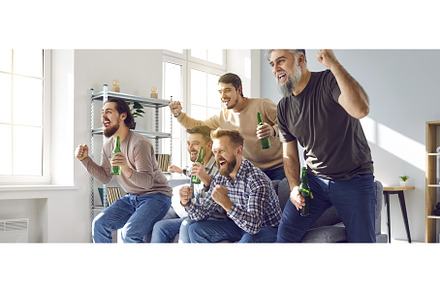 Male football fans watching soccer