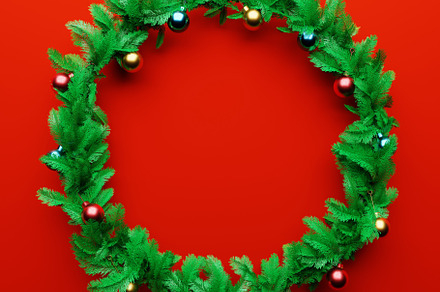 Christmas garland pine decoration with empty space in the middle on red backgro, a Holiday Photo by Ministocker
