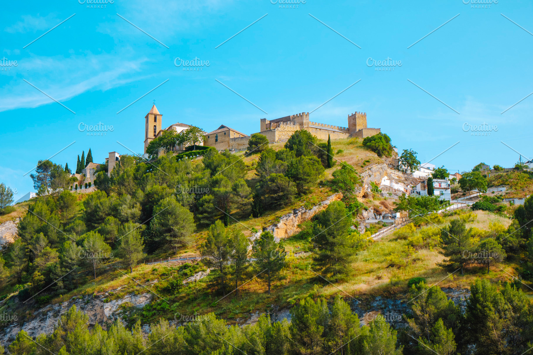 castle and church tower above the hill in Iznajar, a Photo by Nito