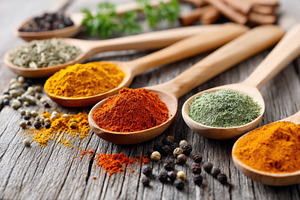 Colorful spices in wooden spoons on rustic table, a Food & Drink Photo by AlyaAnd