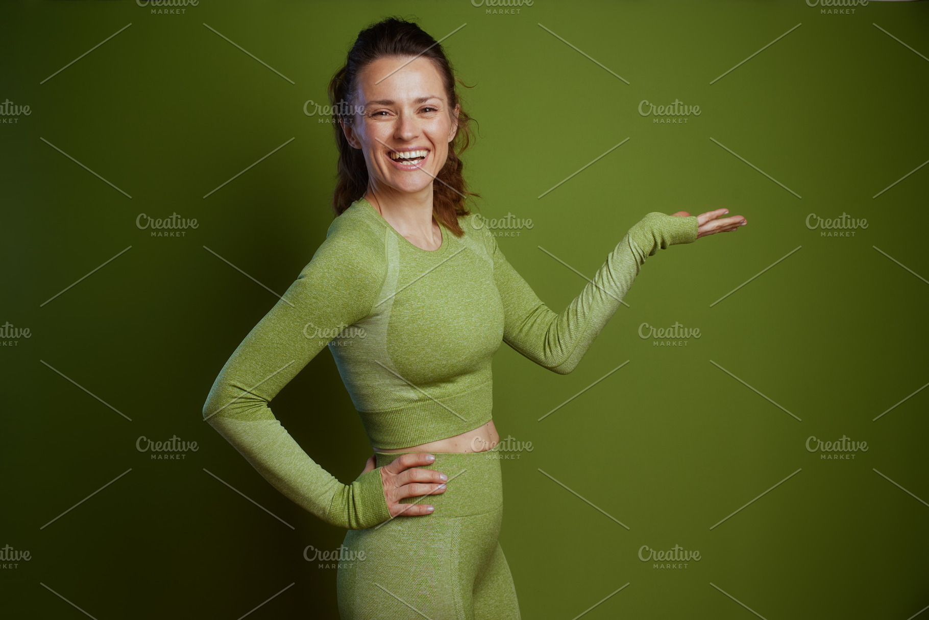 Friendly fitness coach in green activewear, a Person Photo by Alliance Images