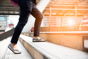 Close up of woman legs walking up stair in the city. Business an