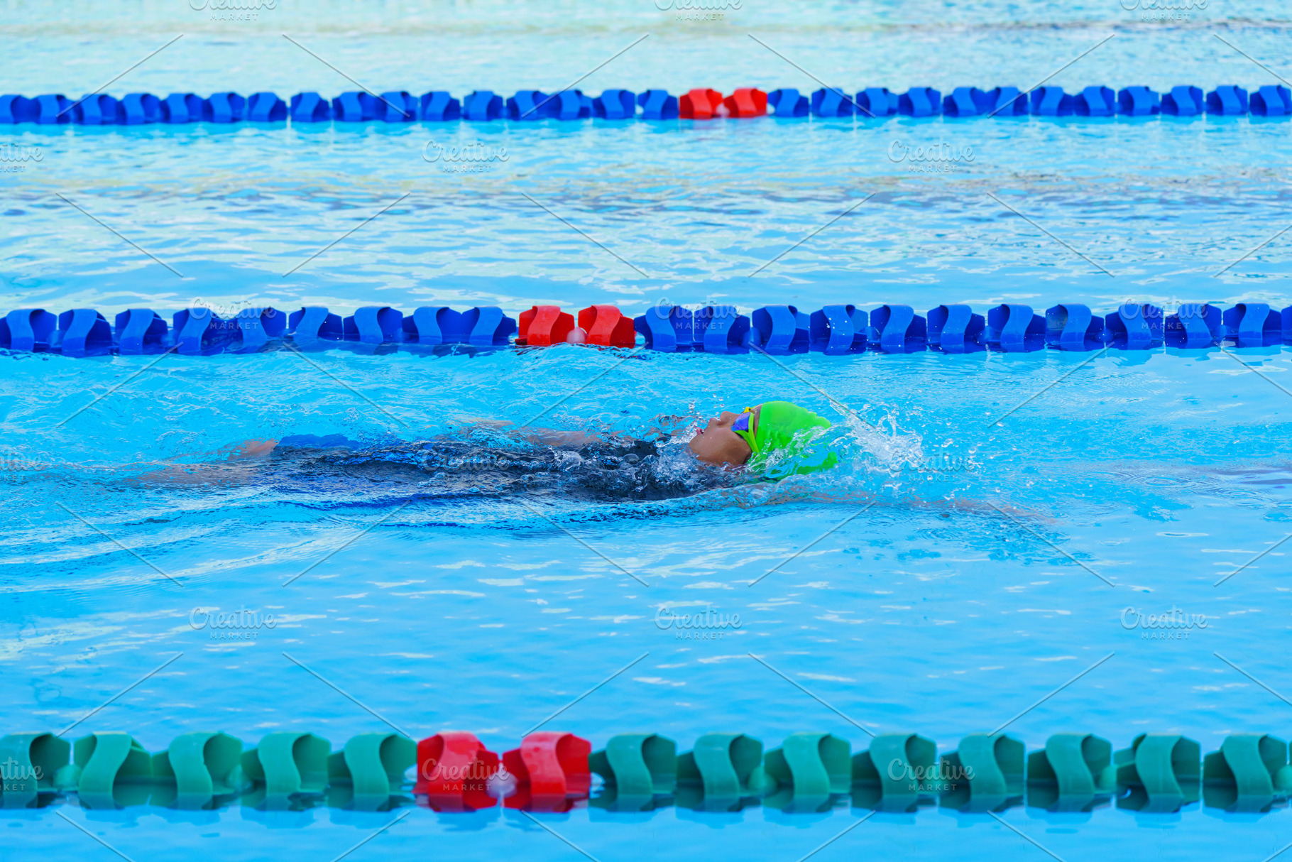 Swimmer child swims backstroke swimming style in a race swimming, a Sports & Recreation Photo by Casanowe-studio