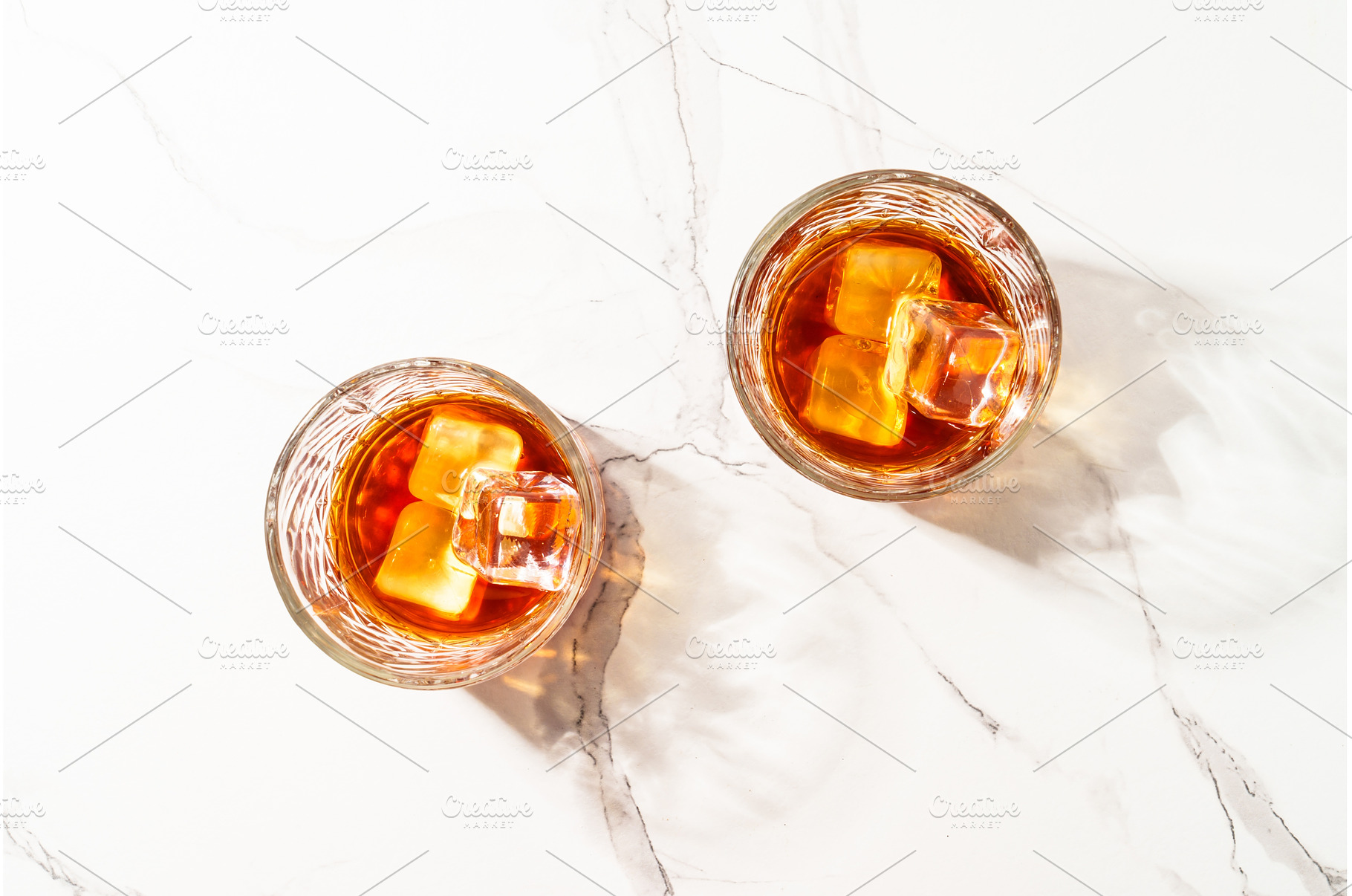 Whiskey with ice cube in the glass, a Food & Drink Photo by Nadia-nb