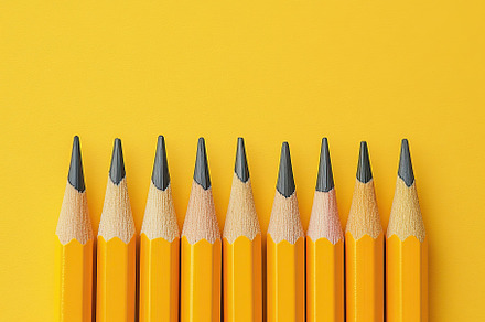 Wooden pencils on yellow background, a Background Photo by AlyaAnd