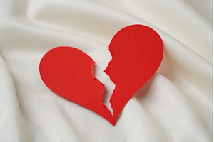 Broken red heart on white textile, an Abstract Photo by Voodz_shop