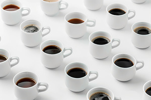 Different cups of coffee on white background, a Food & Drink Photo by AlyaAnd