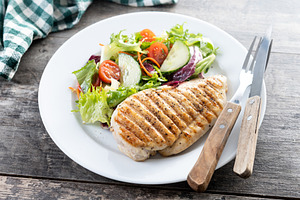 Healthy grilled chicken with salad on wooden table, a Food & Drink Photo by etorres69