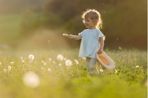 Cute girl playing on meadow, in, a Person Photo by HalfPoint
