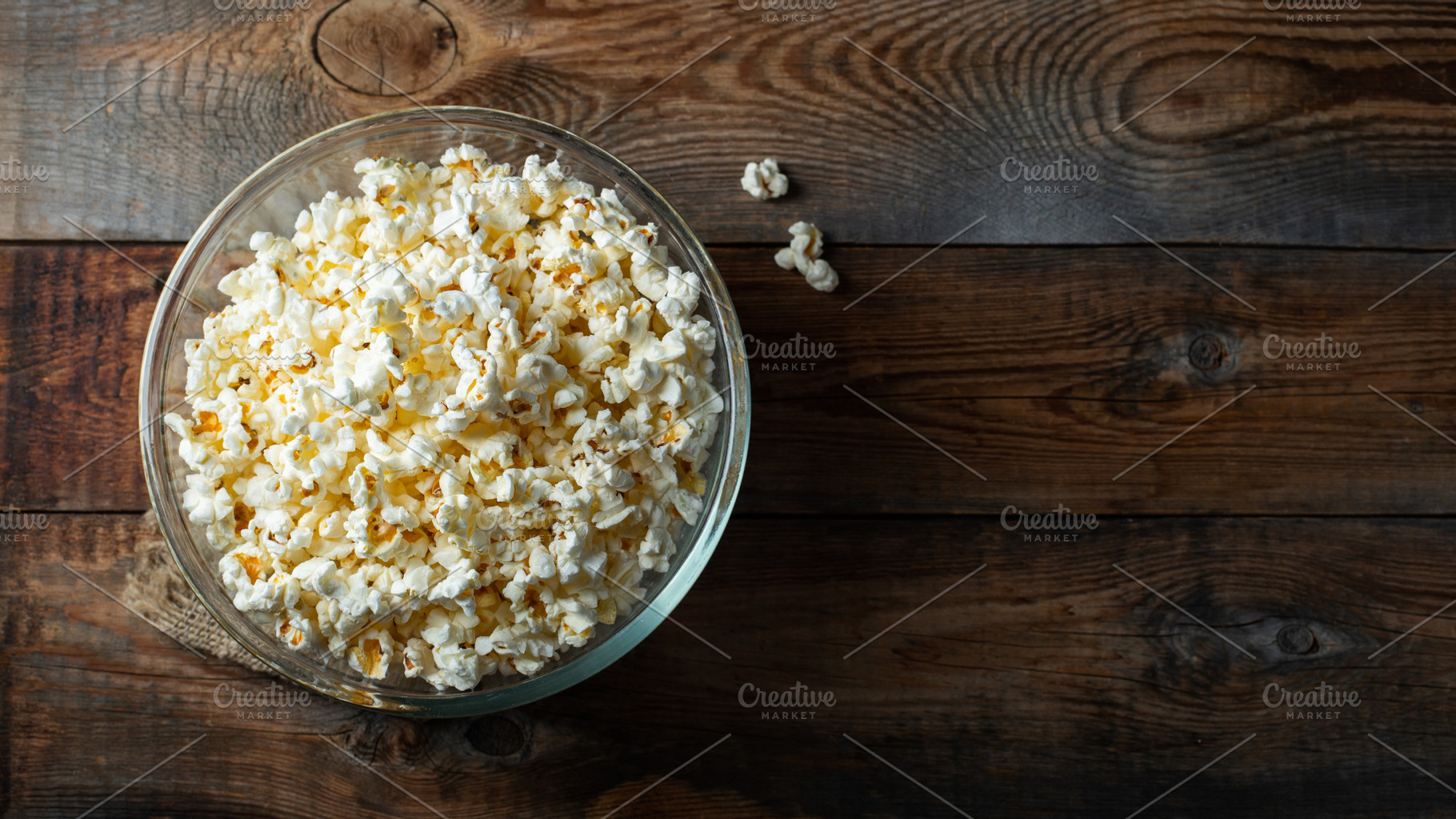 Popcorn on wood color background.Food and snack concepts ideas.Minimal style to, a Food & Drink Photo by Budarinphoto