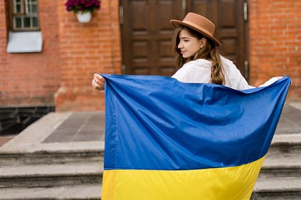 Girl standing in Ukrainian flag