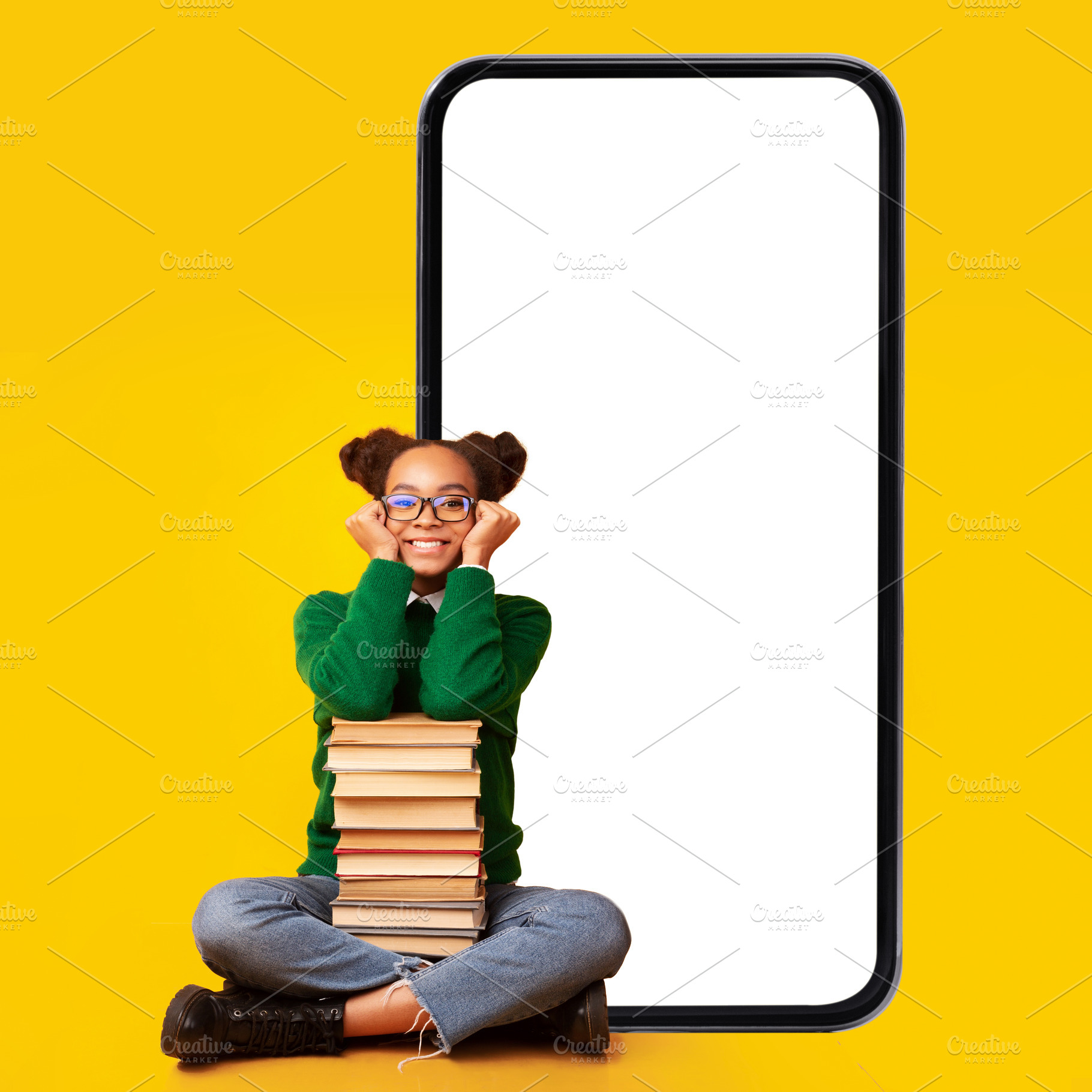 Black teen girl sitting near smartphone and books, yellow background, a Photo by Prostock-Studio
