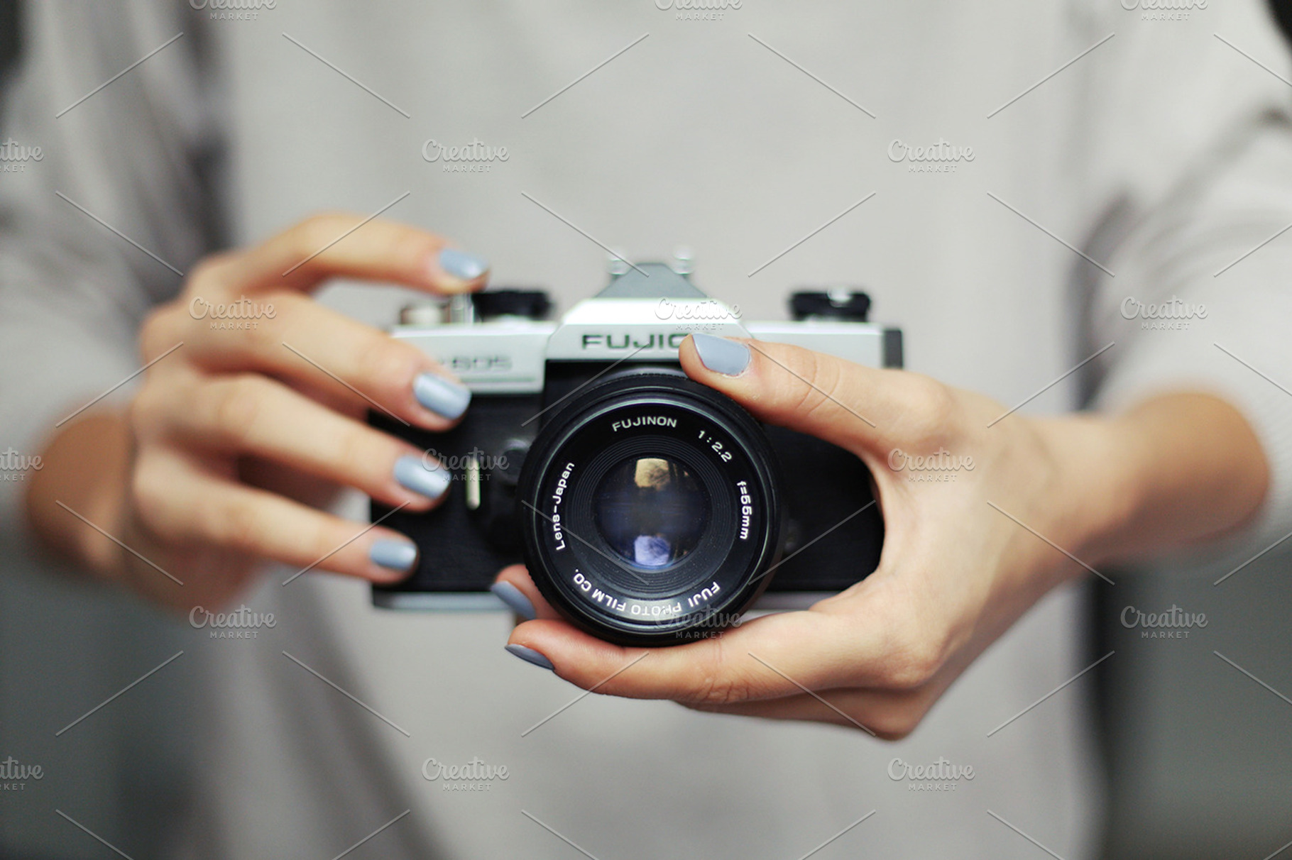 Hands holding vintage camera, a Photo by M. Klasan