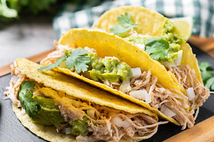 Mexican chicken tacos with guacamole and cilantro