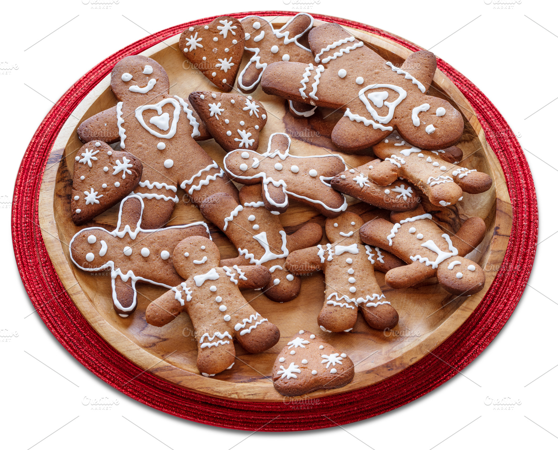 Wooden plate with gingerbread men on white background. File cont, a Food & Drink Photo by Volff