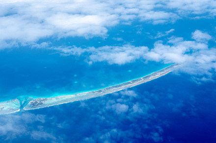 Aerial view of the Tuamotus atoll in French Polynesia with cloud