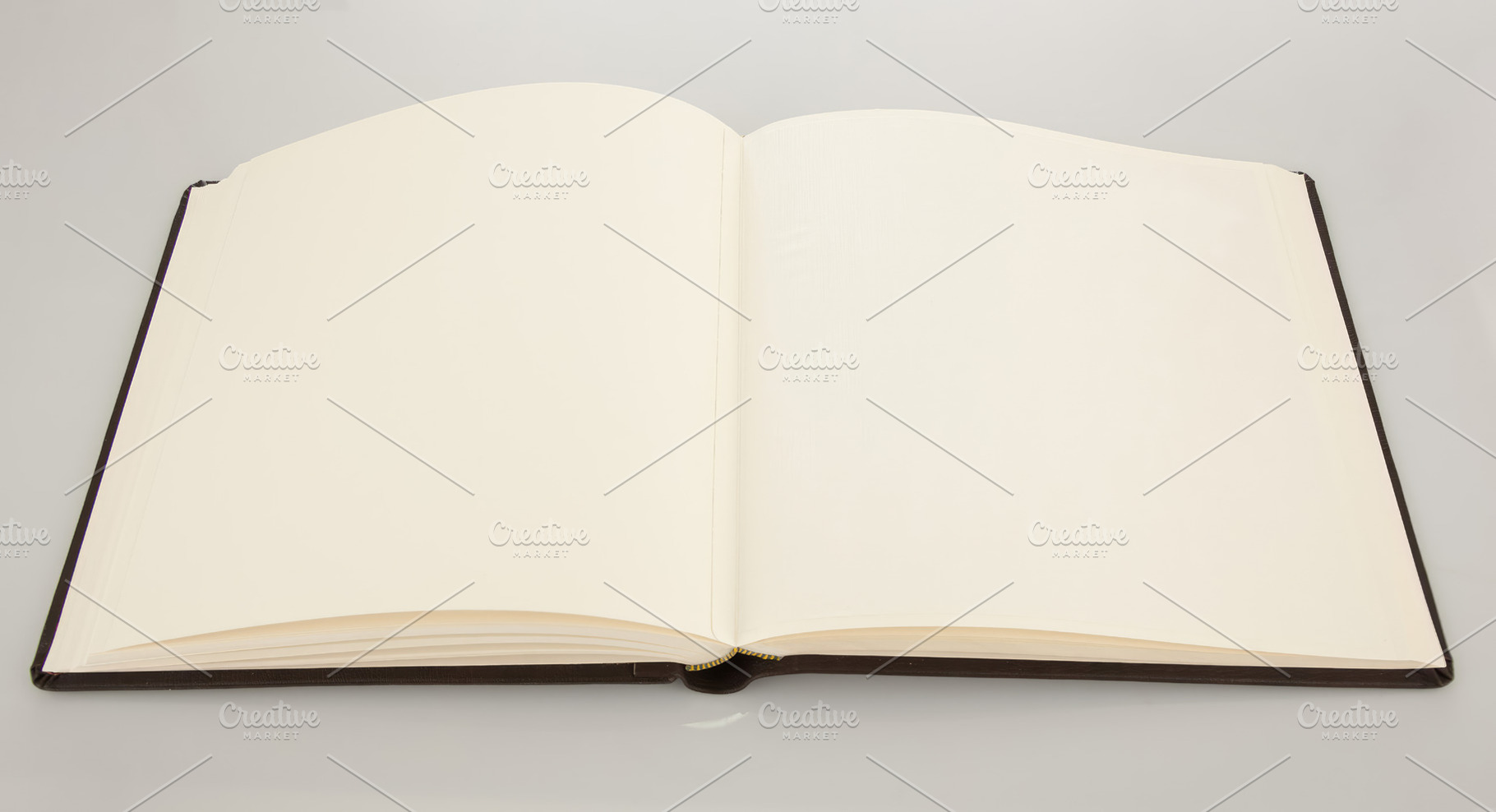 Open book showing blank pages on white background, an Abstract Photo by Antonio Gravante Market