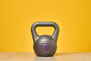 A gray sports kettlebell weighing six kilograms stands on a wood, a Sports & Recreation Photo by ndanko
