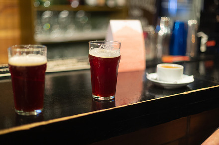 Beer glasses with dark beer are on t containing beer, glass, and alcohol, a Food & Drink Photo by oleghz