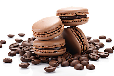 Brown macarons dessert with coffee beans on white background, a Food & Drink Photo by AlyaAnd