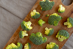 Raw Organic Green Broccoli on a Wooden Board, top view. Copy spa, a Food & Drink Photo by LiudmylaChuhunova