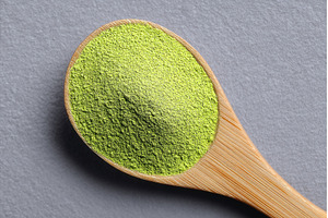 Green barley grass powder sits on a, a Food & Drink Photo by ZinetroN