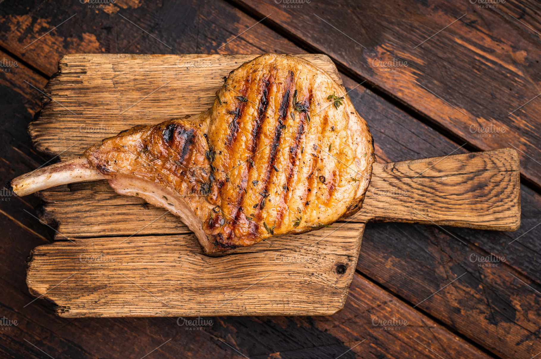 Tender grilled Tomahawk pork chop, showcasing its rich marbling, a Food & Drink Photo by composter-box@mail.ru