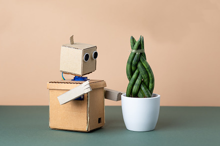 Robot and green plant., a Technology Photo by Nastassia
