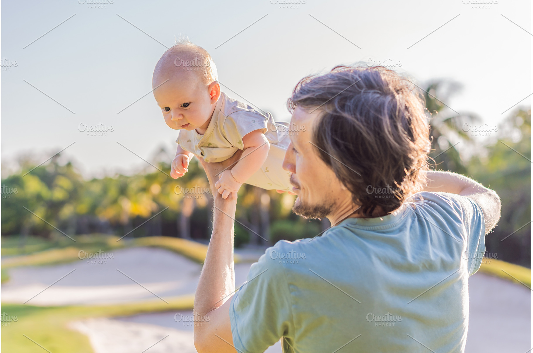 Father and newborn baby on a meadow, a Person Photo by Elizaveta Galitskaya