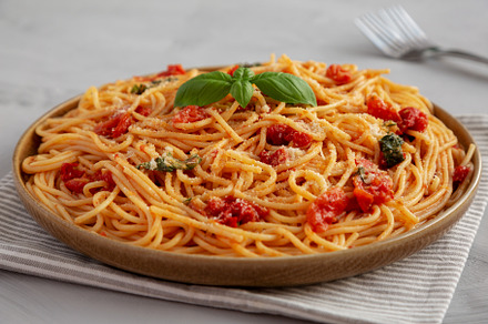 Homemade Spaghetti With Fresh Tomato Sauce on a Plate, side view, a Food & Drink Photo by LiudmylaChuhunova