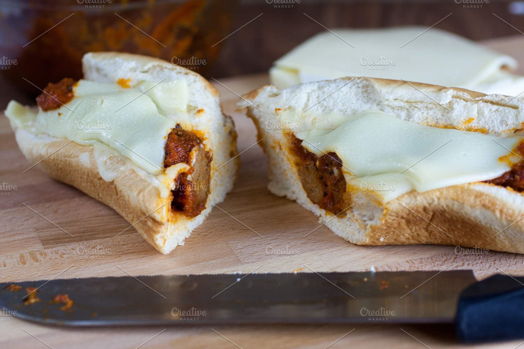 Meatball sandwich featuring bread, cheese, and cutting board, a Food & Drink Photo by Southern Light