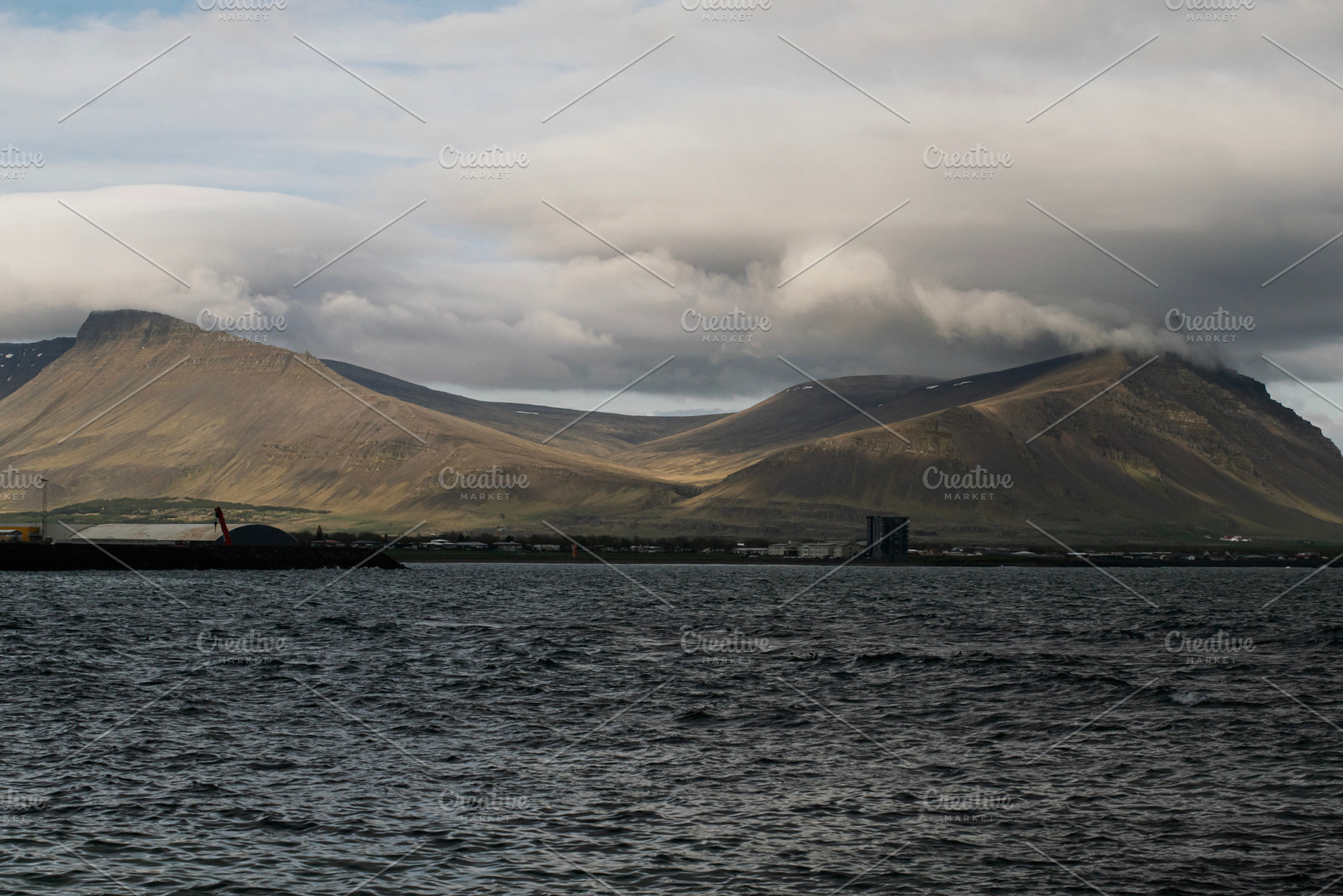 Scenic view of Akranes mountains and waterfront in Iceland under cloudy skies, a Photo by AS photostudio