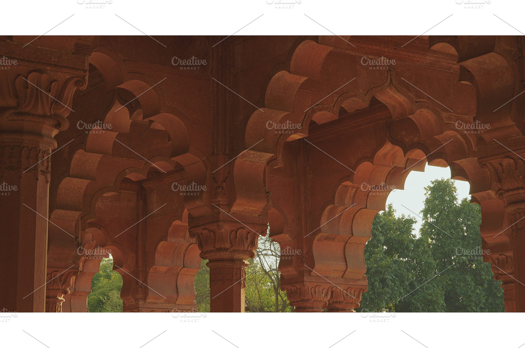 Intricate carved capitals and red, an Architecture Photo by Our Amazing World