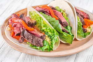 Three carne asada tacos, a Food & Drink Photo by Alexander Prokopenko