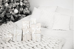 Christmas presents lying on cozy, a Holiday Photo by Anna Efetova