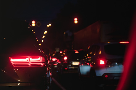 Car taillights in blur on the evening road at rush hour, a Transportation Photo by TanaCh
