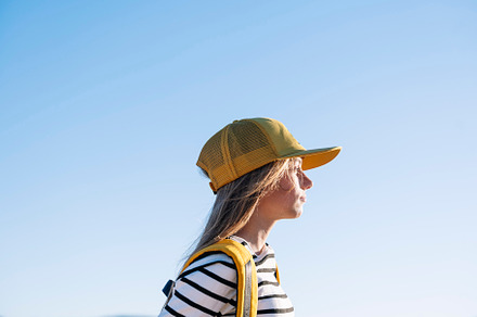 Outdoor portrait of a beautiful young blonde woman in a yellow cap and a bracke, a Person Photo by karrastock