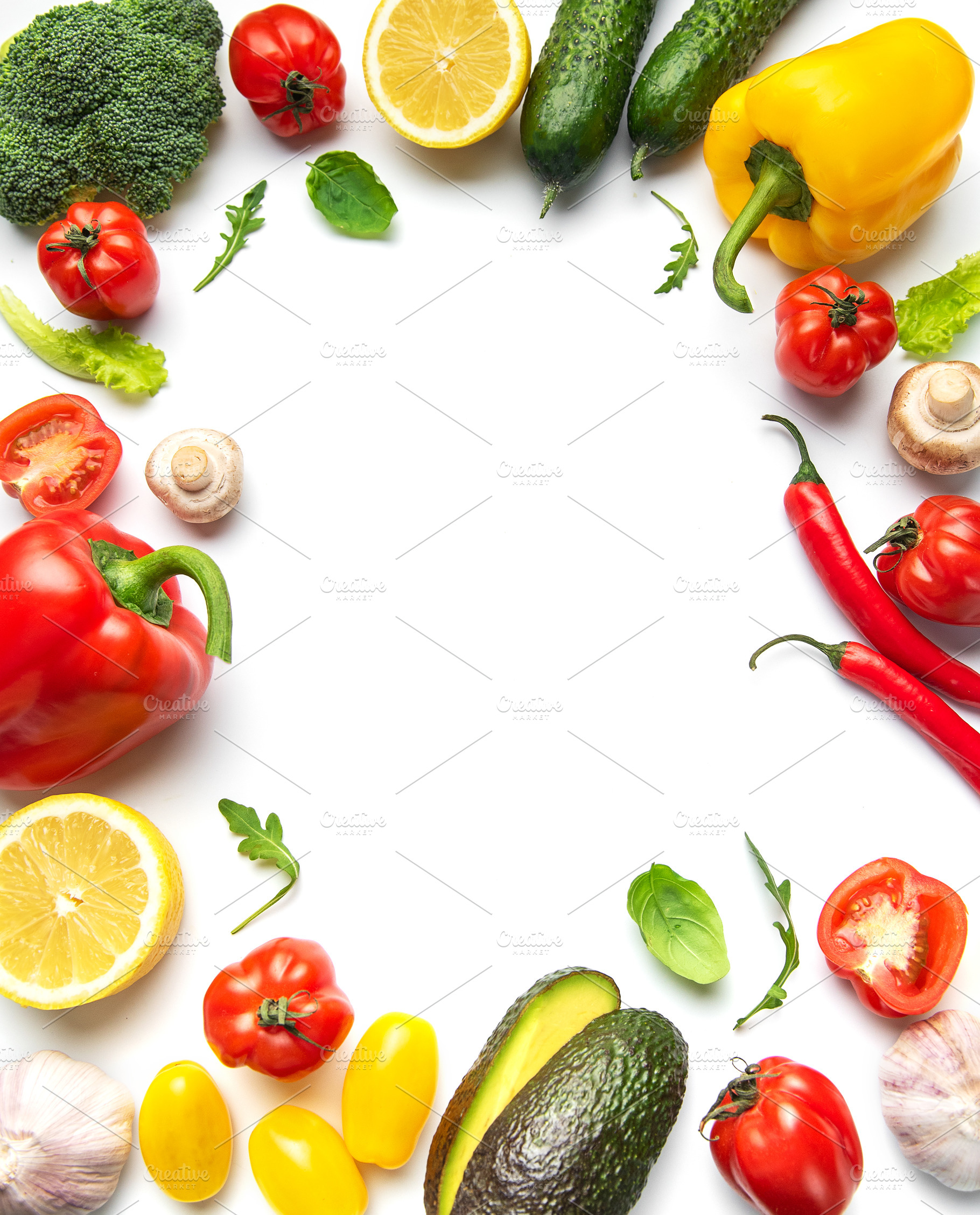 Fresh organic vegetables creating border on white background, a Food & Drink Photo by Olena Rudo