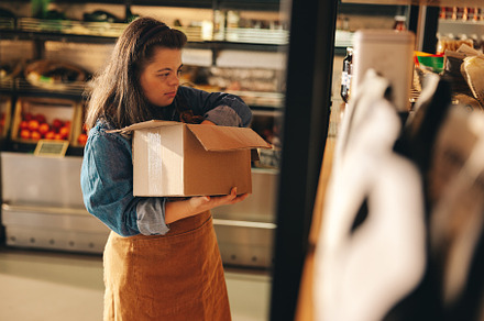 Grocery store employee with Down syndrome restocking food produc, a Person Photo by Jacob Lund