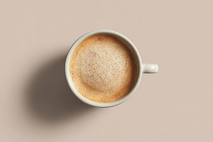 Minimalist overhead shot of a ceramic coffee cup filled with cre, an Abstract Photo by Ales Munt
